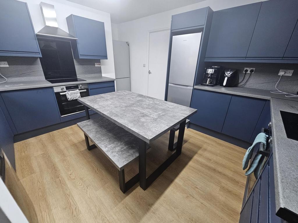 A modern, well-maintained kitchen with sleek bl...