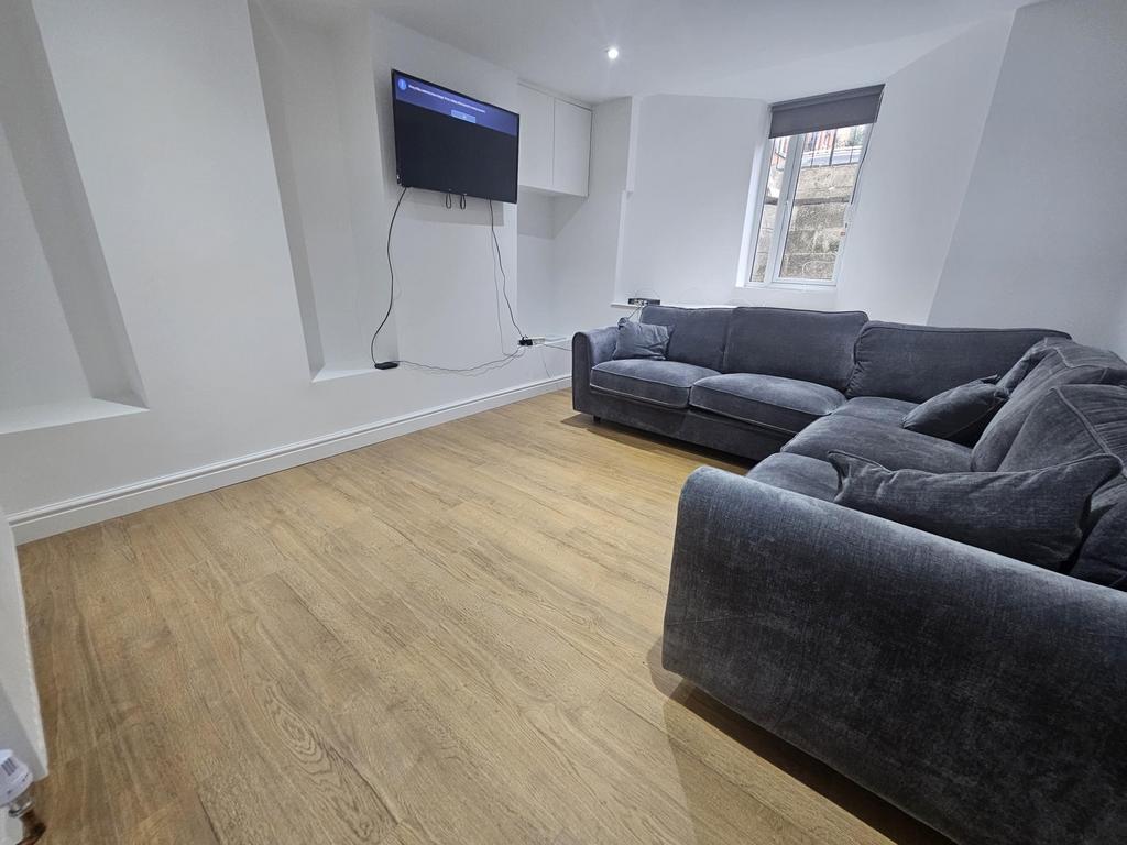 A spacious and bright living room featuring mod...