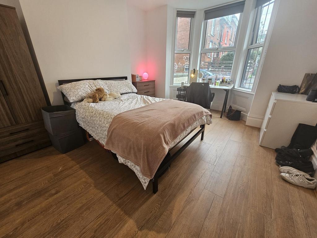 A spacious and well-lit master bedroom featurin...