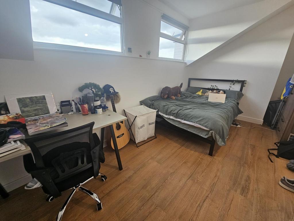 A bright, well-maintained bedroom featuring a c...