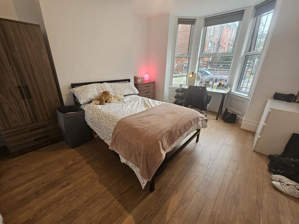 A spacious and well-lit master bedroom featurin...