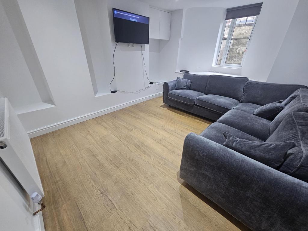 A bright and modern living room featuring a com...