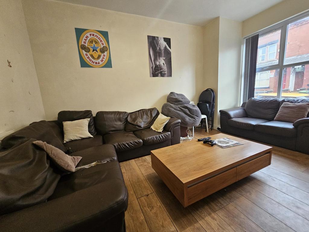 A spacious and inviting living room featuring a...