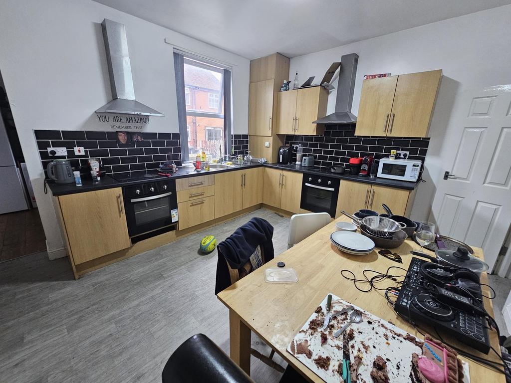 A bright and modern kitchen with ample cabinetr...