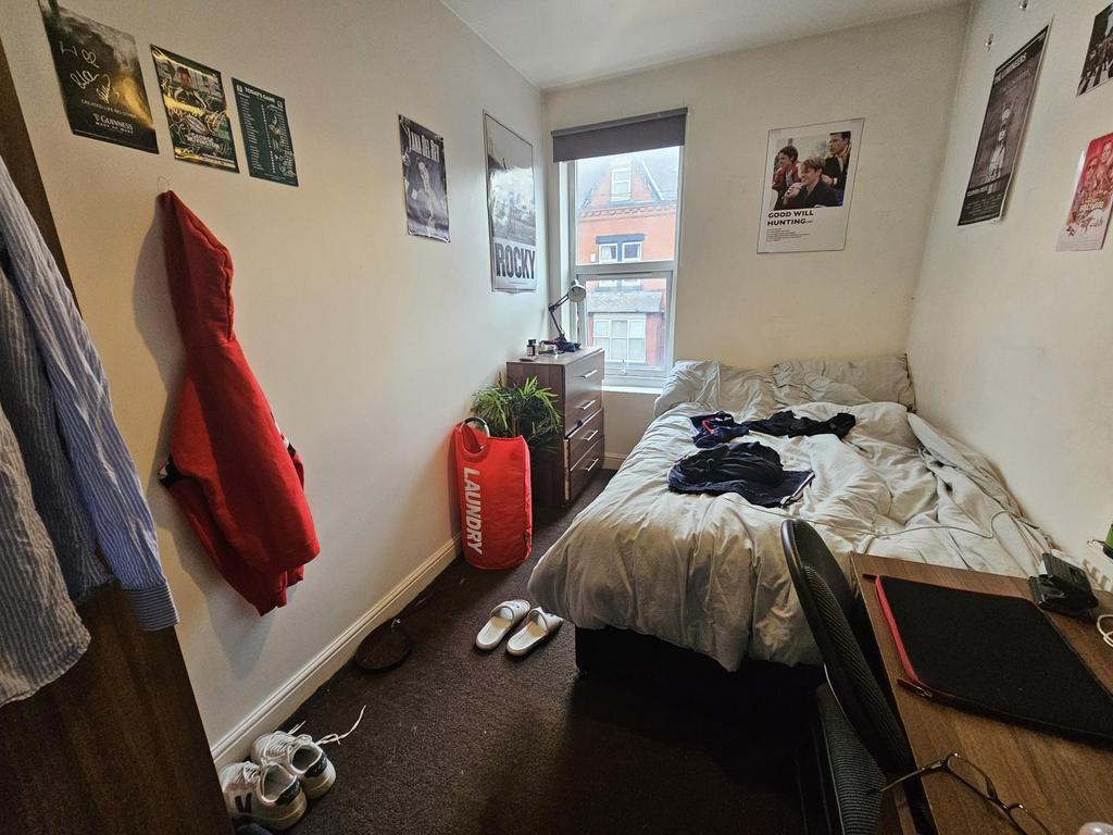 A spacious and cozy master bedroom featuring a ...