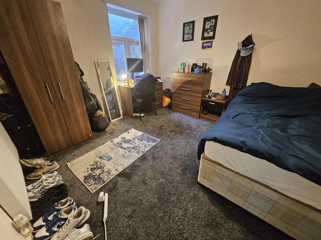 A cozy bedroom featuring a large bed, a window ...