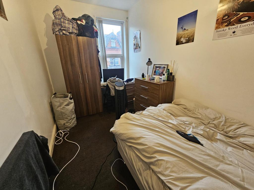 A comfortable student bedroom featuring a singl...