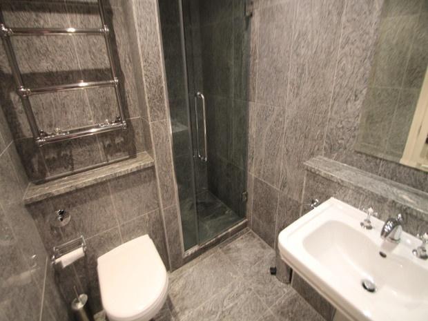 A modern, clean bathroom with a white toilet an...