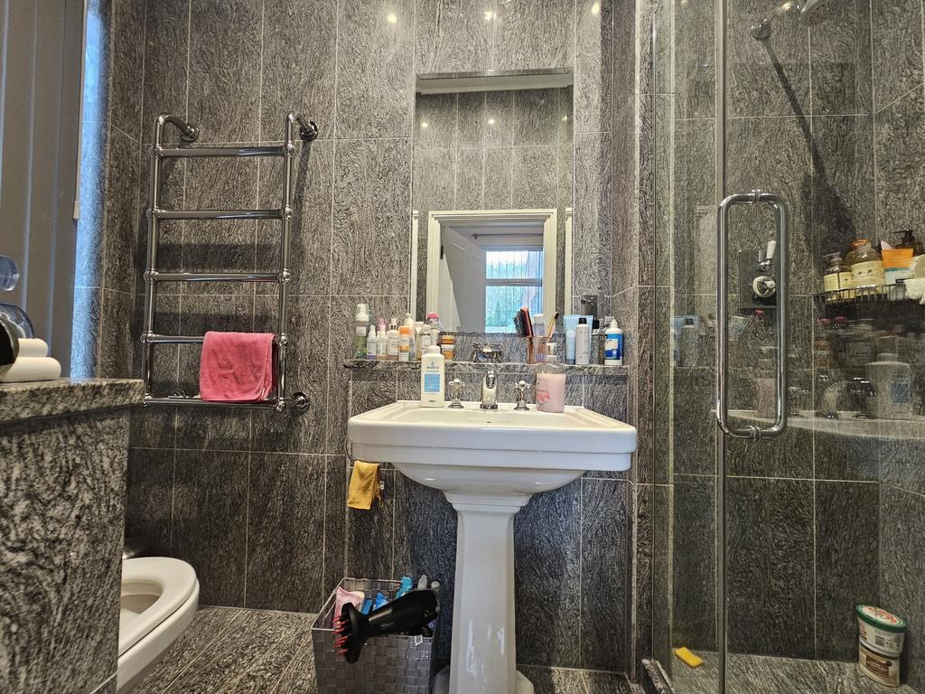 Modern bathroom with a sink, mirror, and shower...