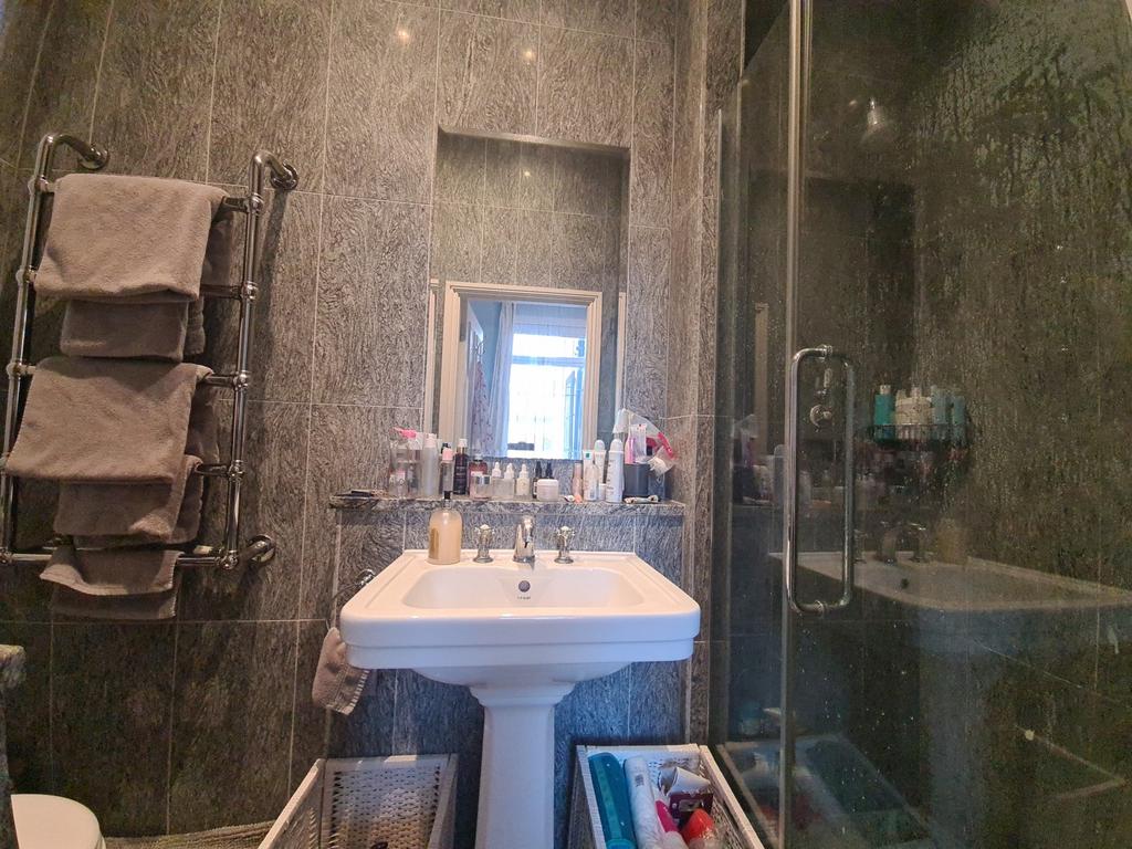 A modern bathroom with a large sink and ample s...