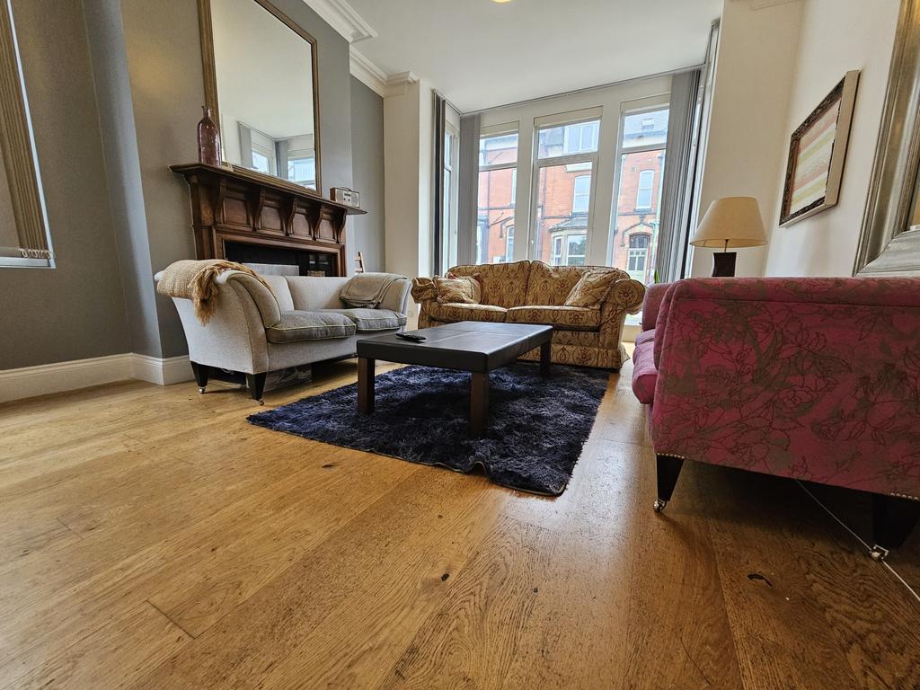 A bright and welcoming living room featuring co...