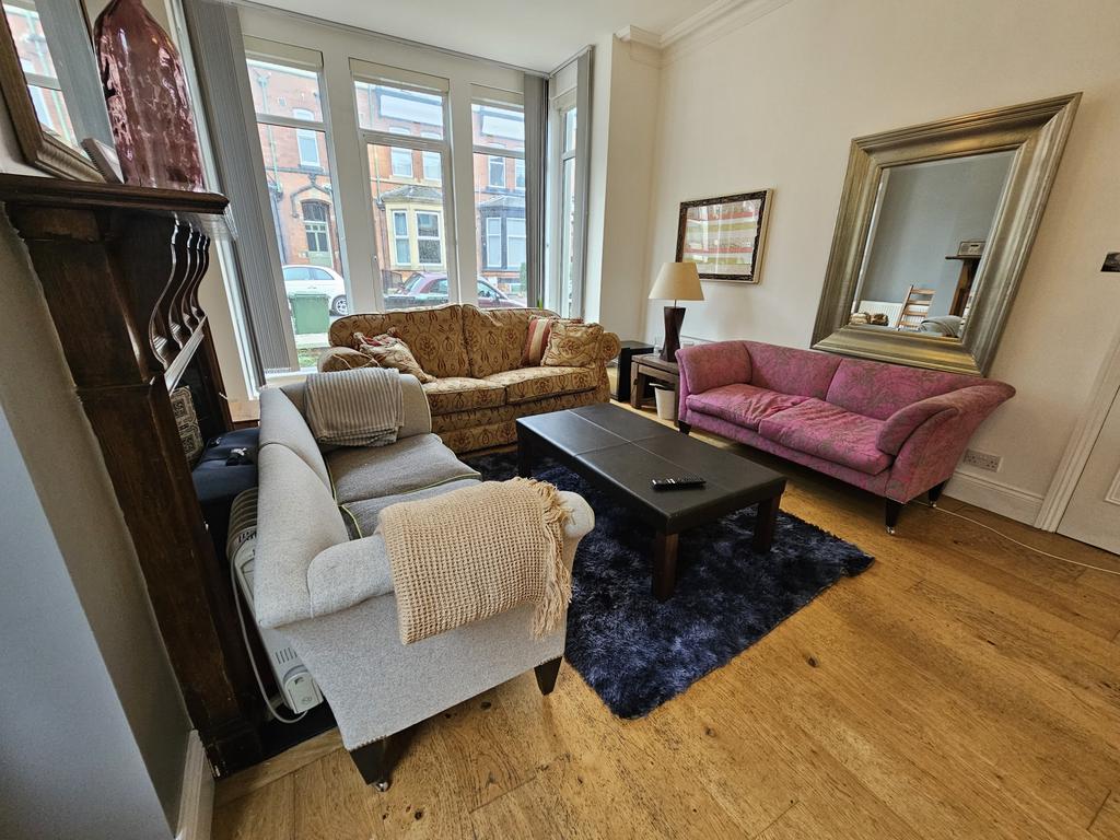 A bright and welcoming living room featuring a ...