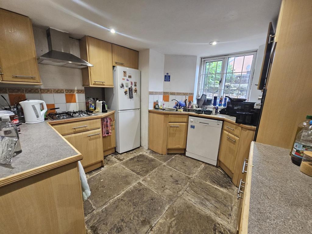 A well-maintained kitchen with ample natural li...