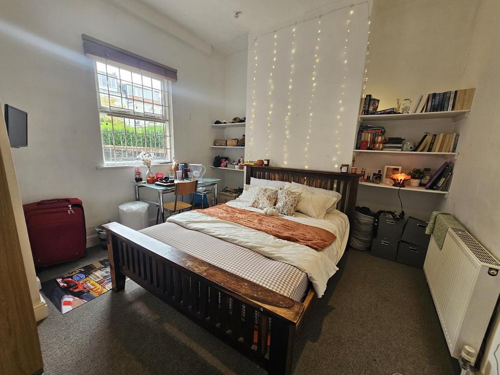 A cozy bedroom featuring a double bed with a st...