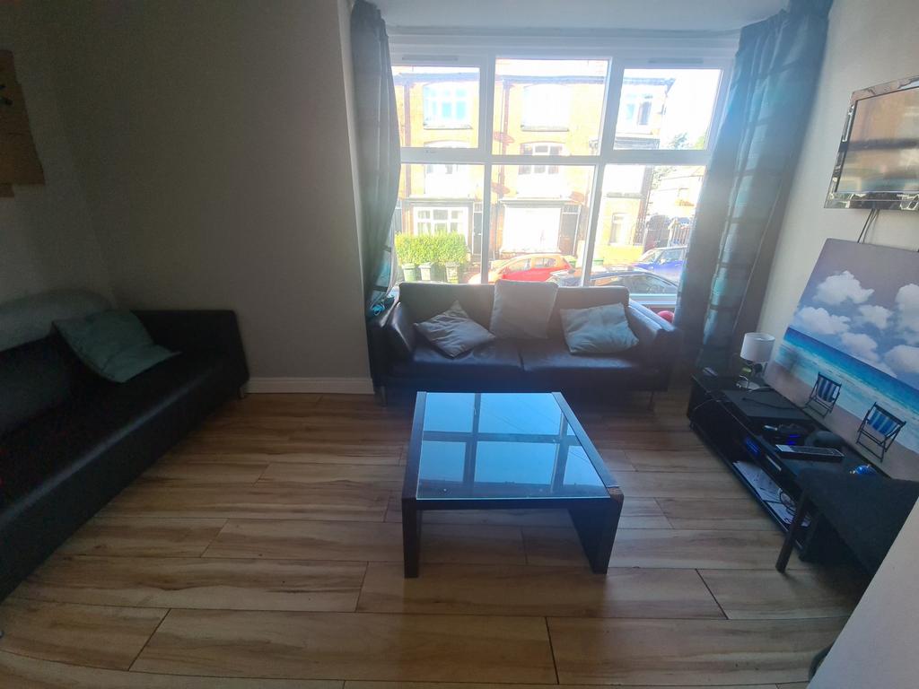 A spacious living room illuminated by ample nat...