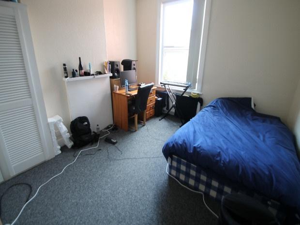 A cozy bedroom featuring a double bed with bedd...