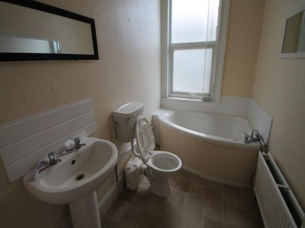 A spacious and well-maintained bathroom featuri...