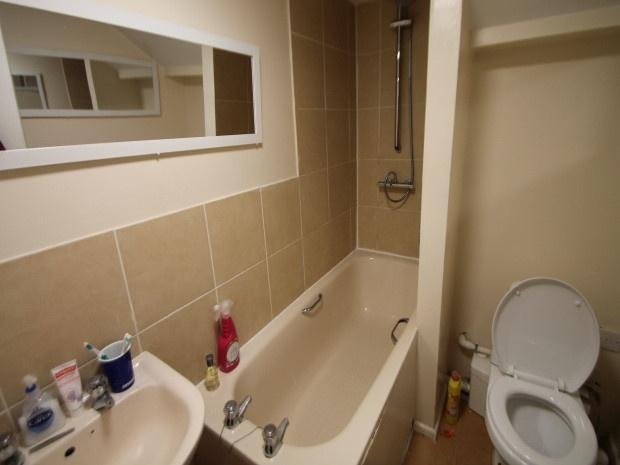 A well-maintained bathroom with a bathtub, toil...