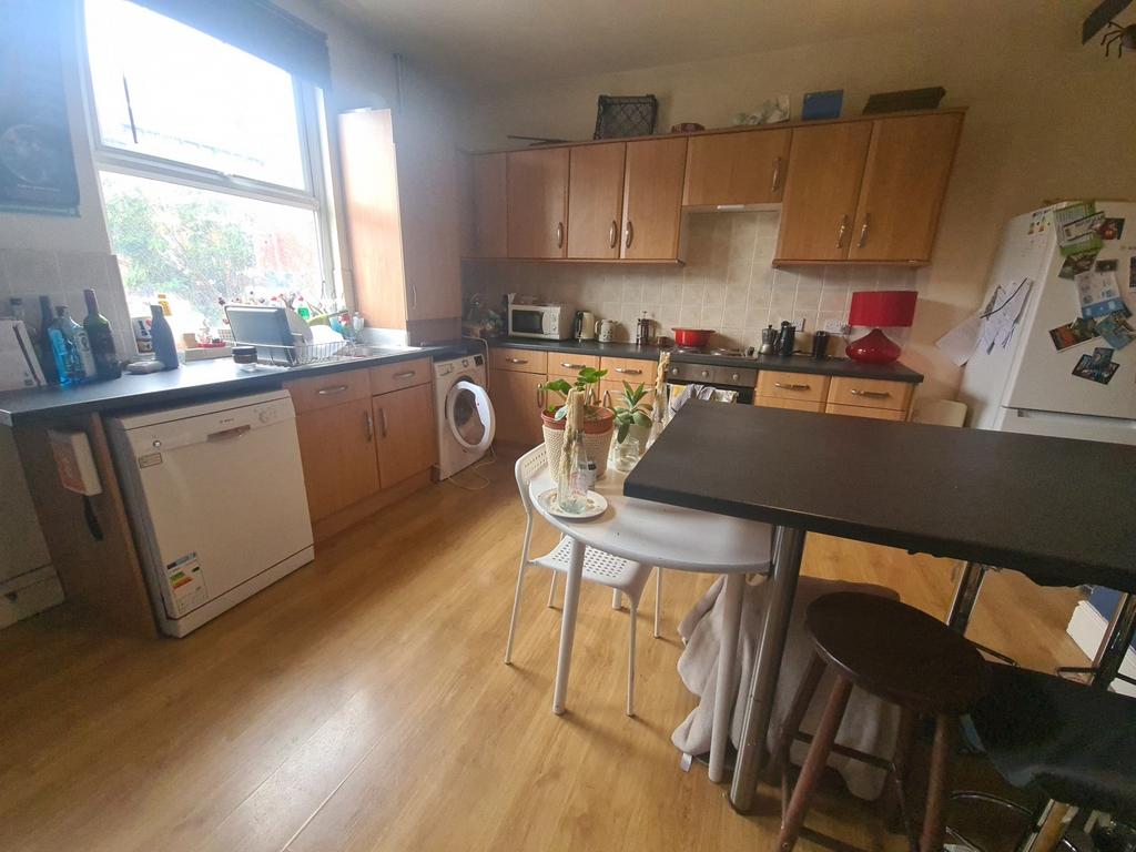 Bright and welcoming kitchen with ample natural...