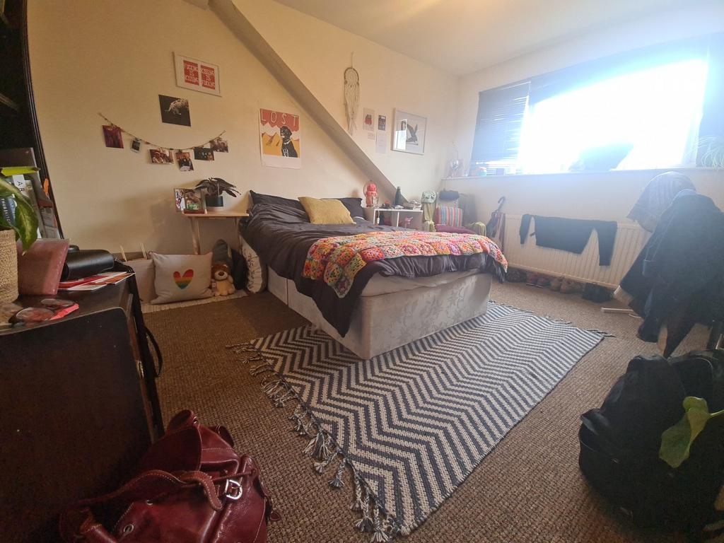 A cozy bedroom featuring a double bed, a study ...