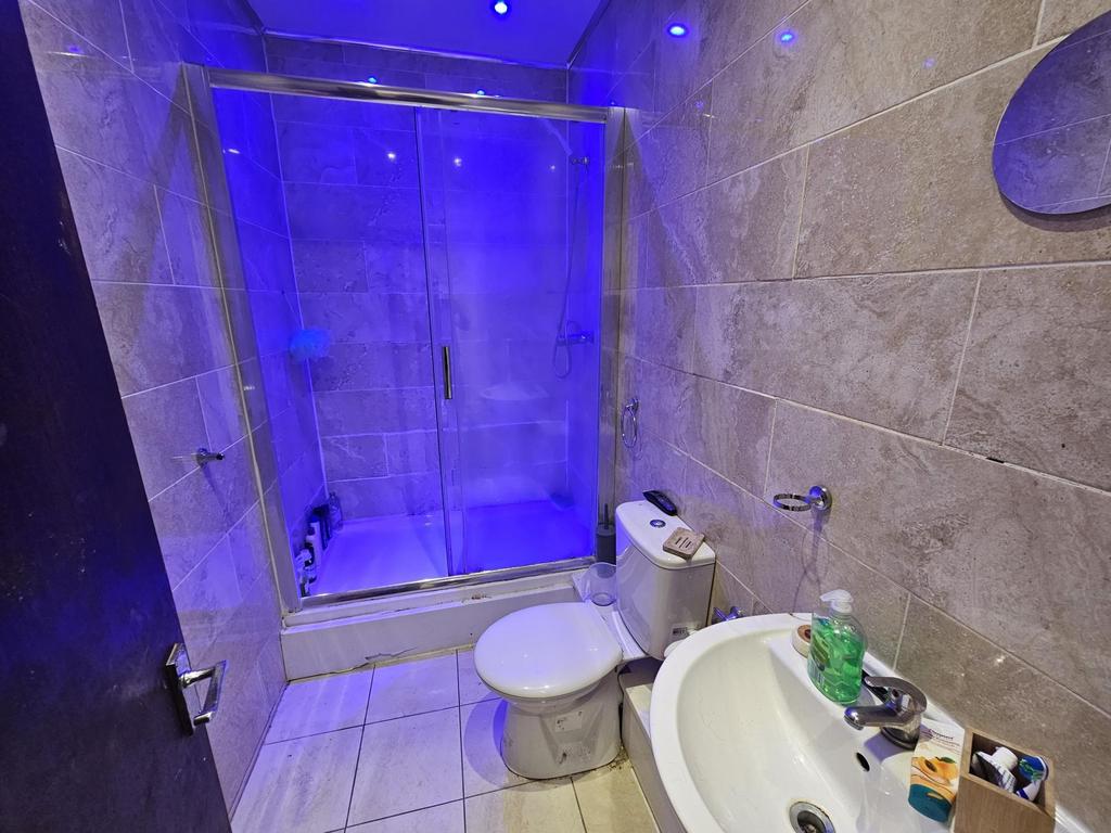 A modern bathroom featuring a large shower encl...