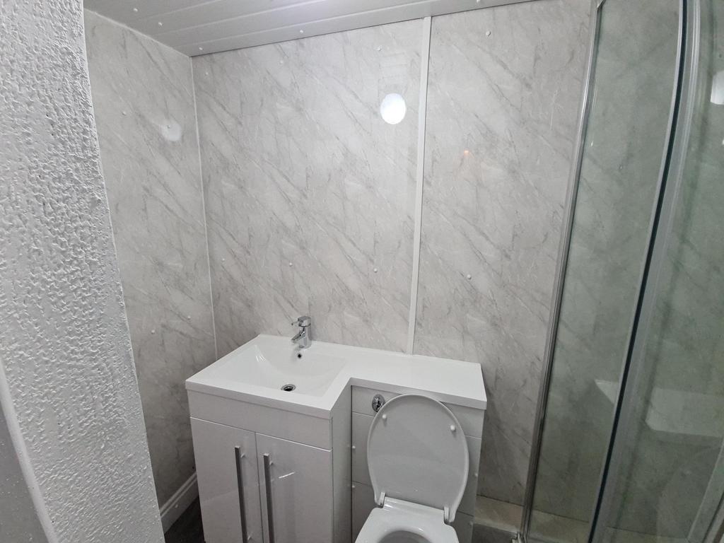 A spacious and modern bathroom featuring a larg...