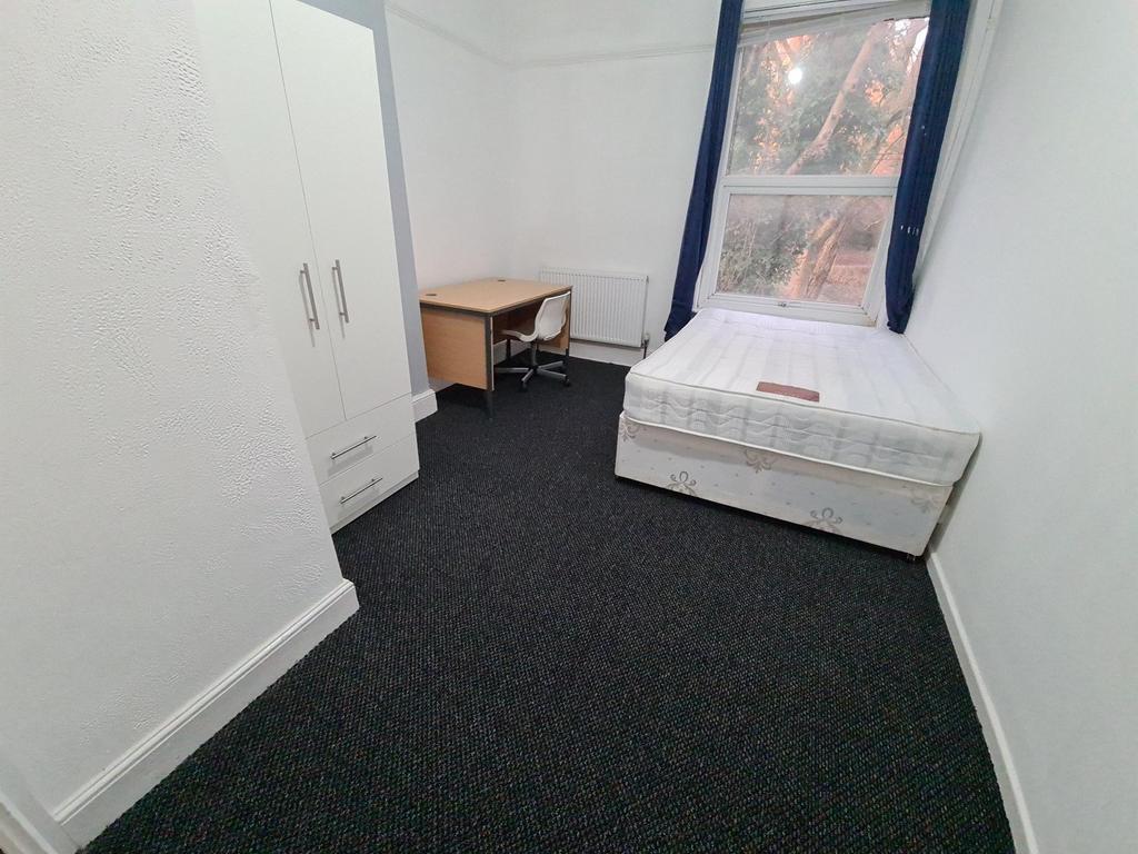 A small, tidy space with a basic toilet setup, ...
