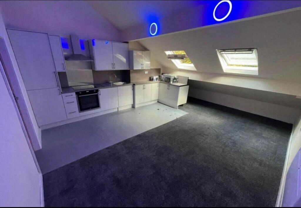 Bright open-plan attic living space with a mode...