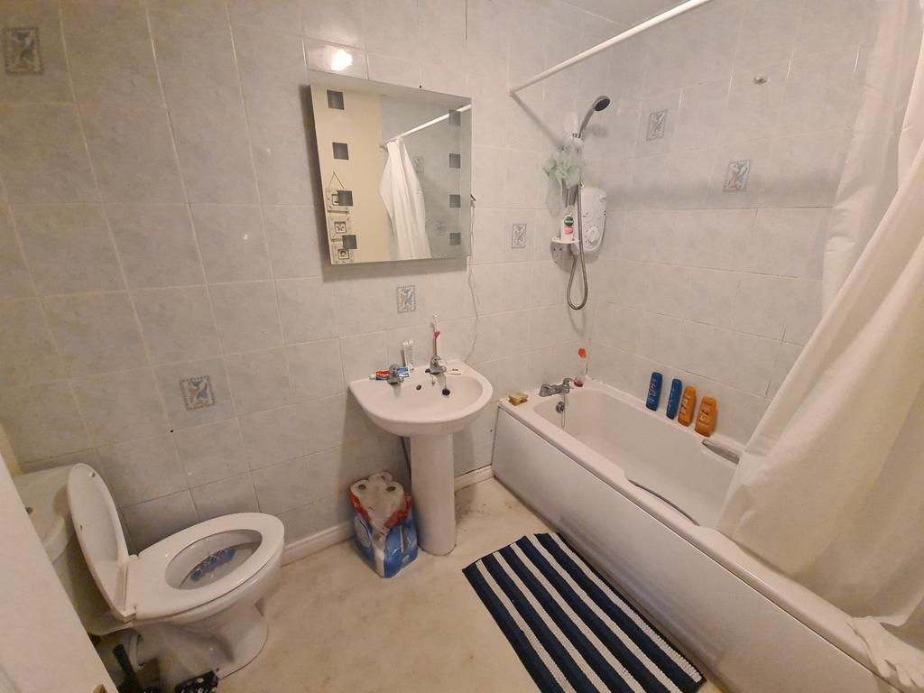 A clean and well-maintained bathroom with a bat...
