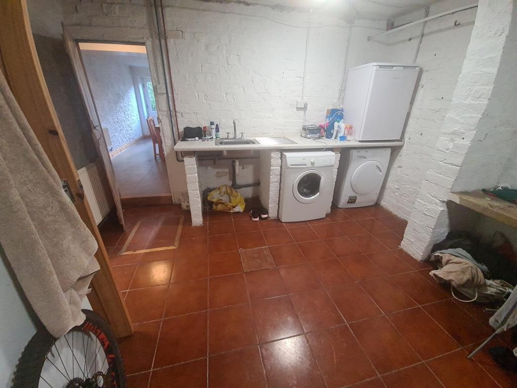 A spacious bathroom featuring a large bathtub, ...