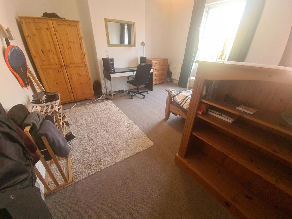 A well-lit, cozy living room with comfortable f...