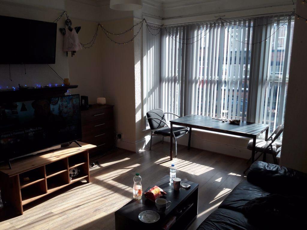 Bright and spacious living room with large wind...