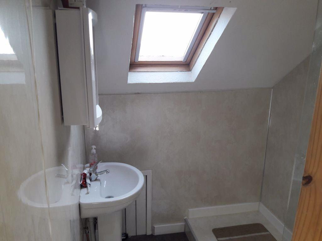 A bright and clean bathroom with a white sink a...