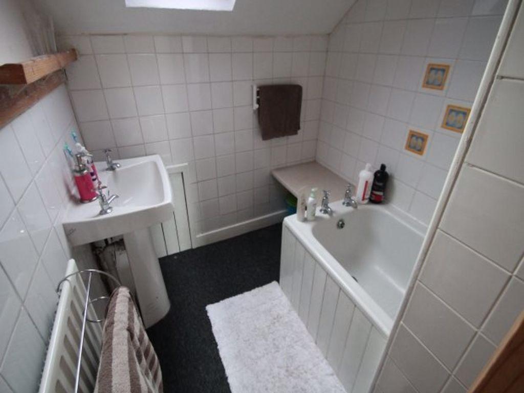 A well-maintained bathroom featuring a bathtub,...