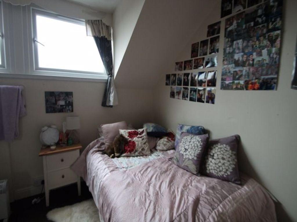 A cozy bedroom featuring a comfortable bed with...