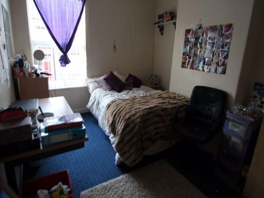 A spacious master bedroom featuring a double be...