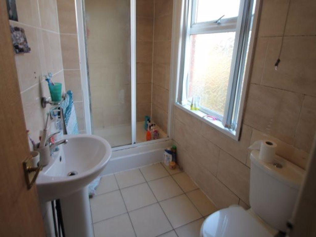 A bright and clean bathroom featuring a shower,...