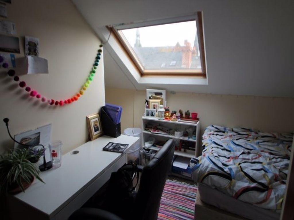 A cozy bedroom with natural light streaming thr...