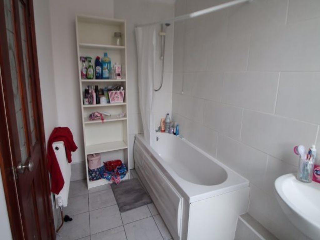 A clean, modern bathroom with a spacious bathtu...