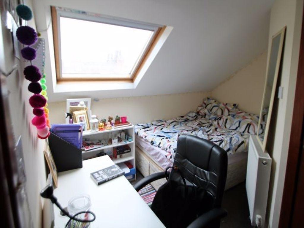 A bright and inviting bedroom featuring a doubl...