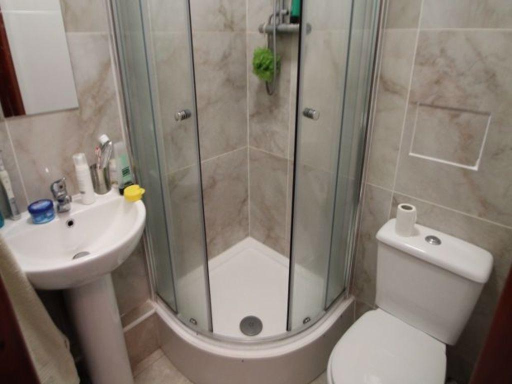 A modern, clean bathroom featuring a large show...