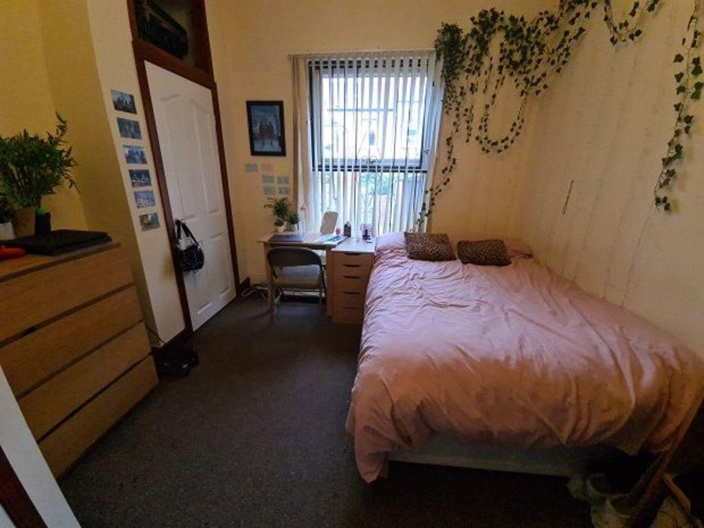 A cozy master bedroom featuring a double bed, a...