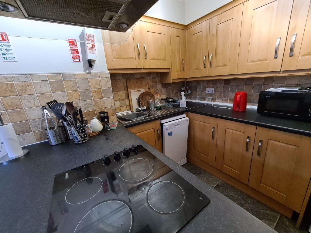 A well-organized kitchen with wooden cabinets, ...