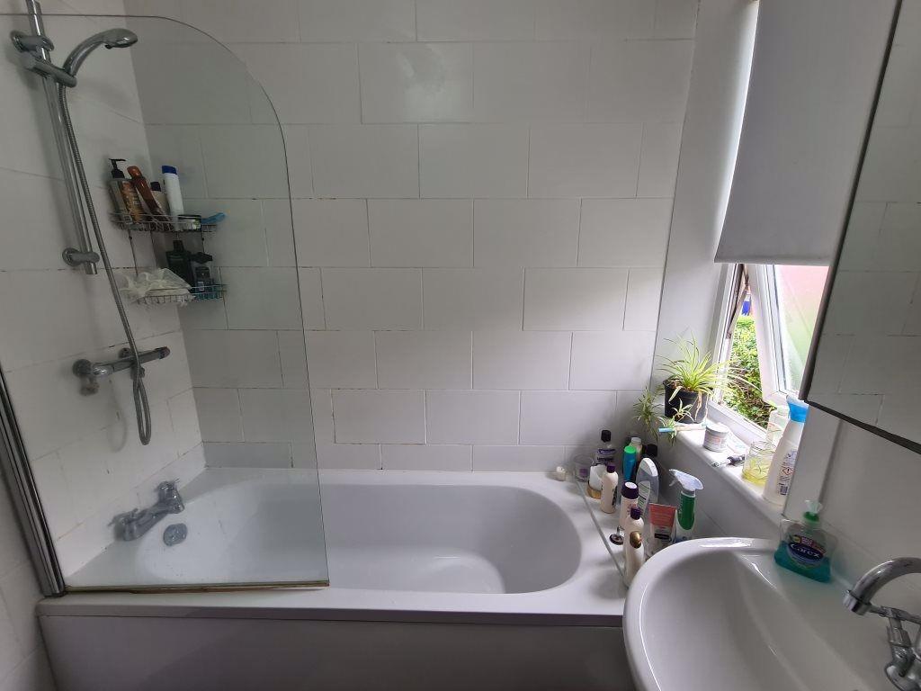 Bright and well-maintained bathroom featuring a...