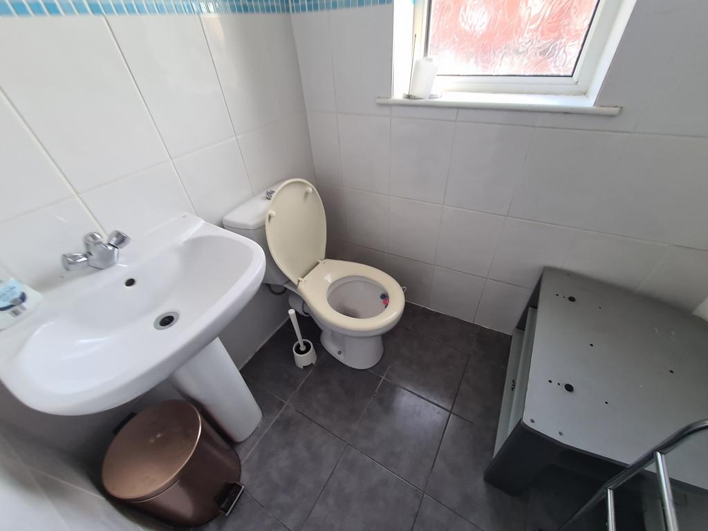 A clean and functional bathroom with a sink, to...