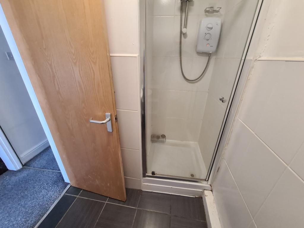 A clean and functional bathroom with a shower, ...