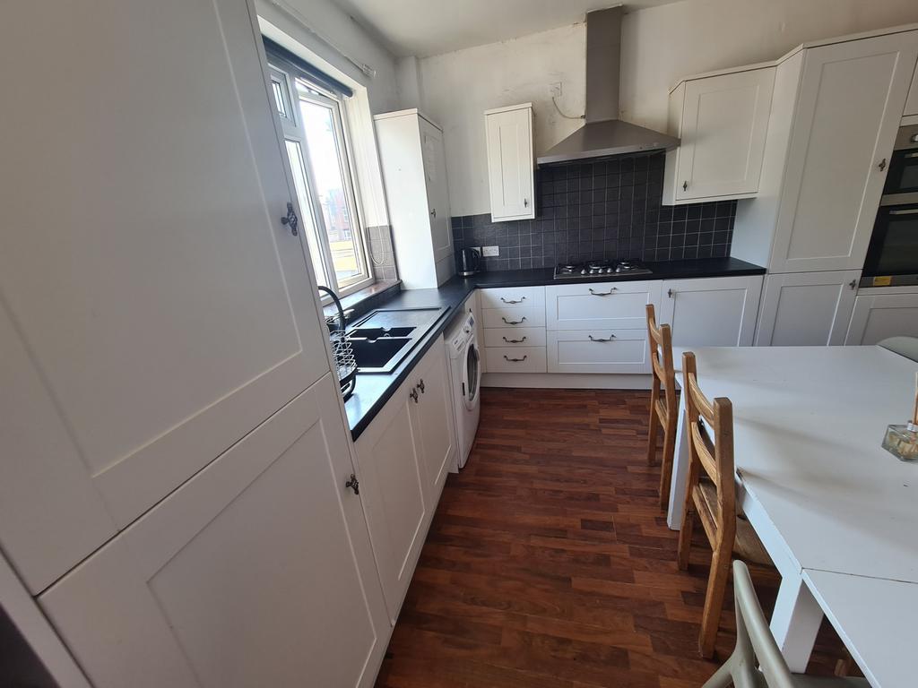 Bright and modern kitchen featuring ample count...