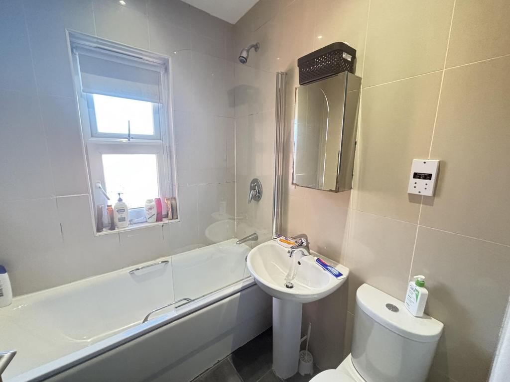 A bright and clean bathroom featuring a spaciou...