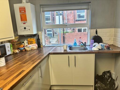 A functional student kitchen with natural light...