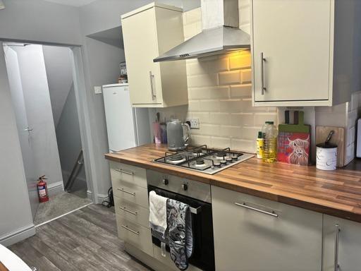 A well-maintained kitchen with modern cabinets,...